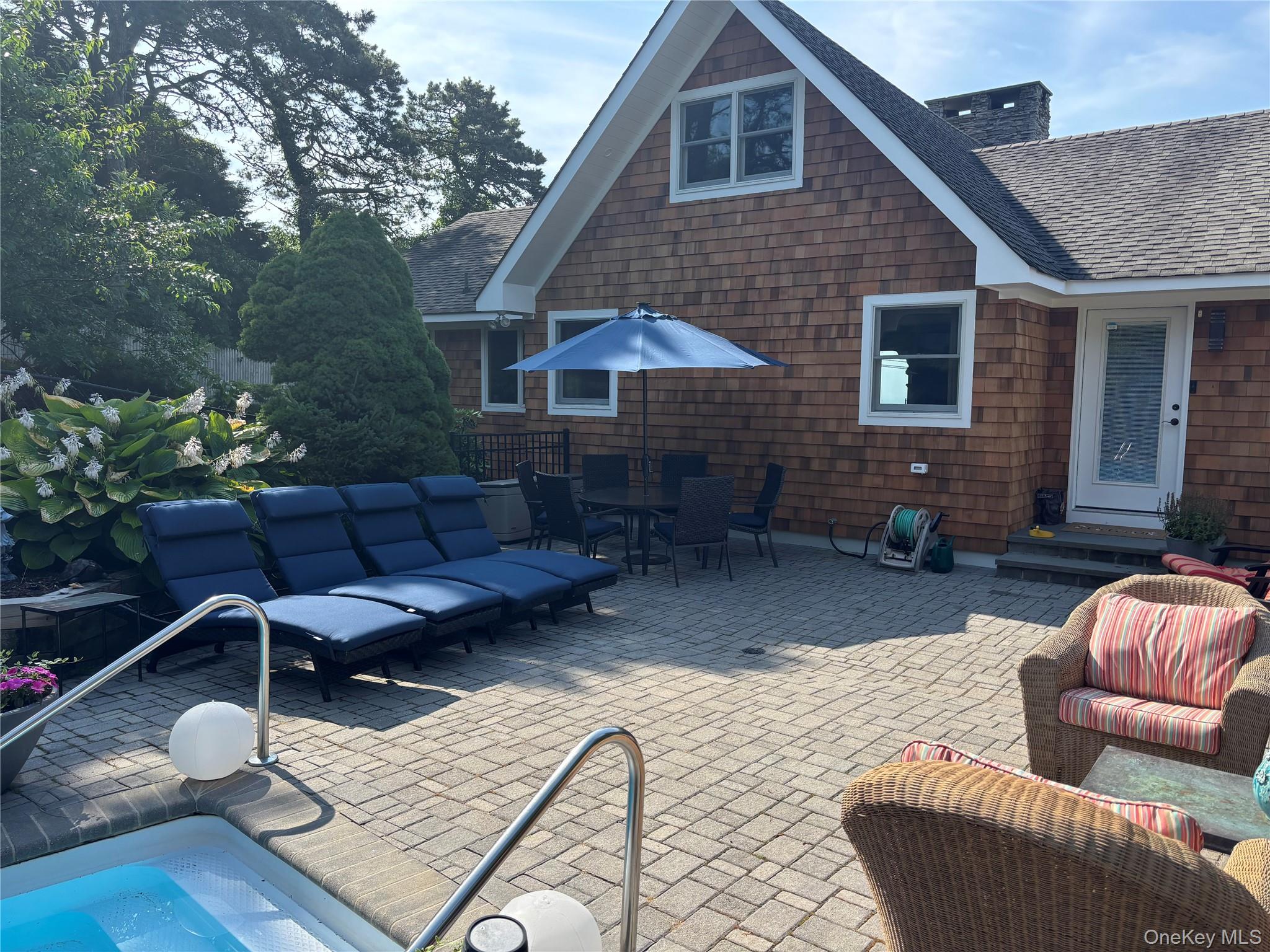 2 West Hillover Road Hampton Bays, NY 11946 - Photo 40 of 42 a view of a patio with couches chairs and wooden floor