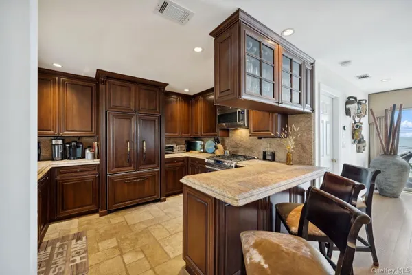 a kitchen with refrigerator cabinets and wooden floor