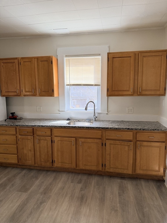 a kitchen with granite countertop cabinets sink and a granite counter top