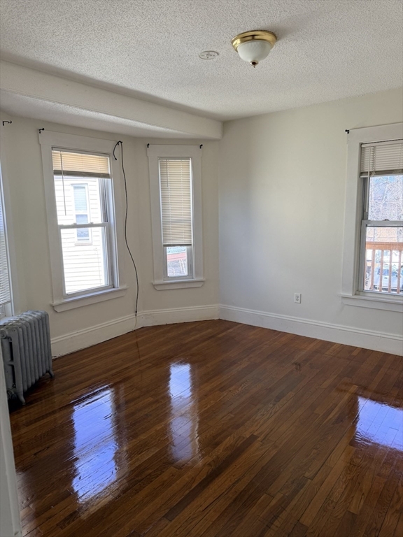 832 Washington Street, Unit 3 Boston, MA 02124 - Photo 13 of 14 a view of empty room with wooden floor and fan