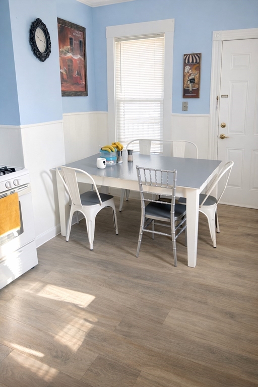832 Washington Street, Unit 3 Boston, MA 02124 - Photo 2 of 14 a dining room with furniture and wooden floor
