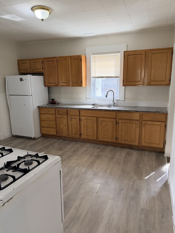 832 Washington Street, Unit 3 Boston, MA 02124 - Photo 3 of 14 a kitchen with sink a stove and cabinets