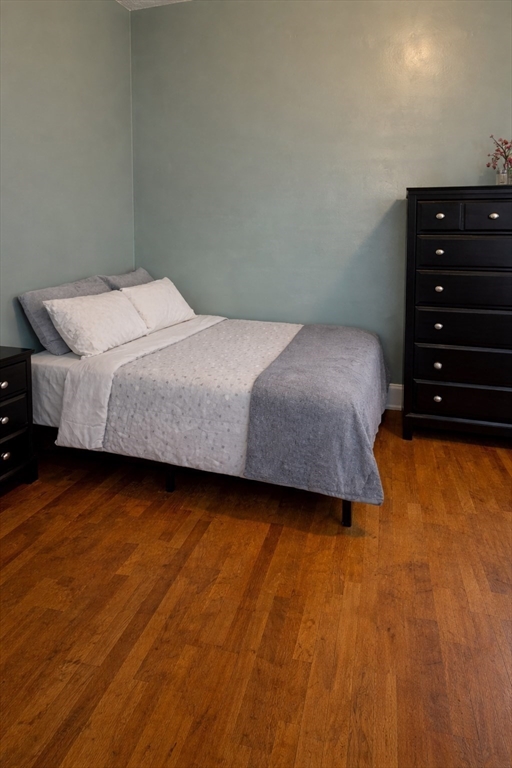 832 Washington Street, Unit 3 Boston, MA 02124 - Photo 5 of 14 a bedroom with a bed and a dresser