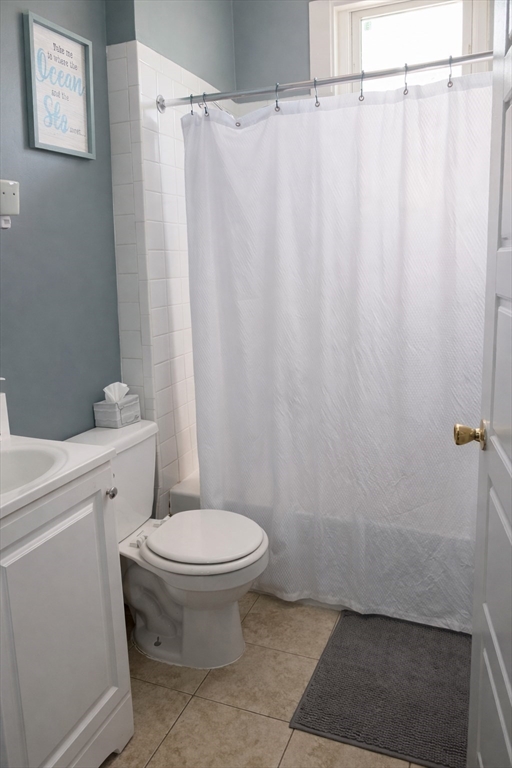 832 Washington Street, Unit 3 Boston, MA 02124 - Photo 6 of 14 a bathroom with a toilet and a shower curtain