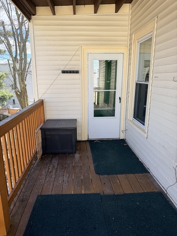 832 Washington Street, Unit 3 Boston, MA 02124 - Photo 8 of 14 a view of a balcony with wooden floor and fence