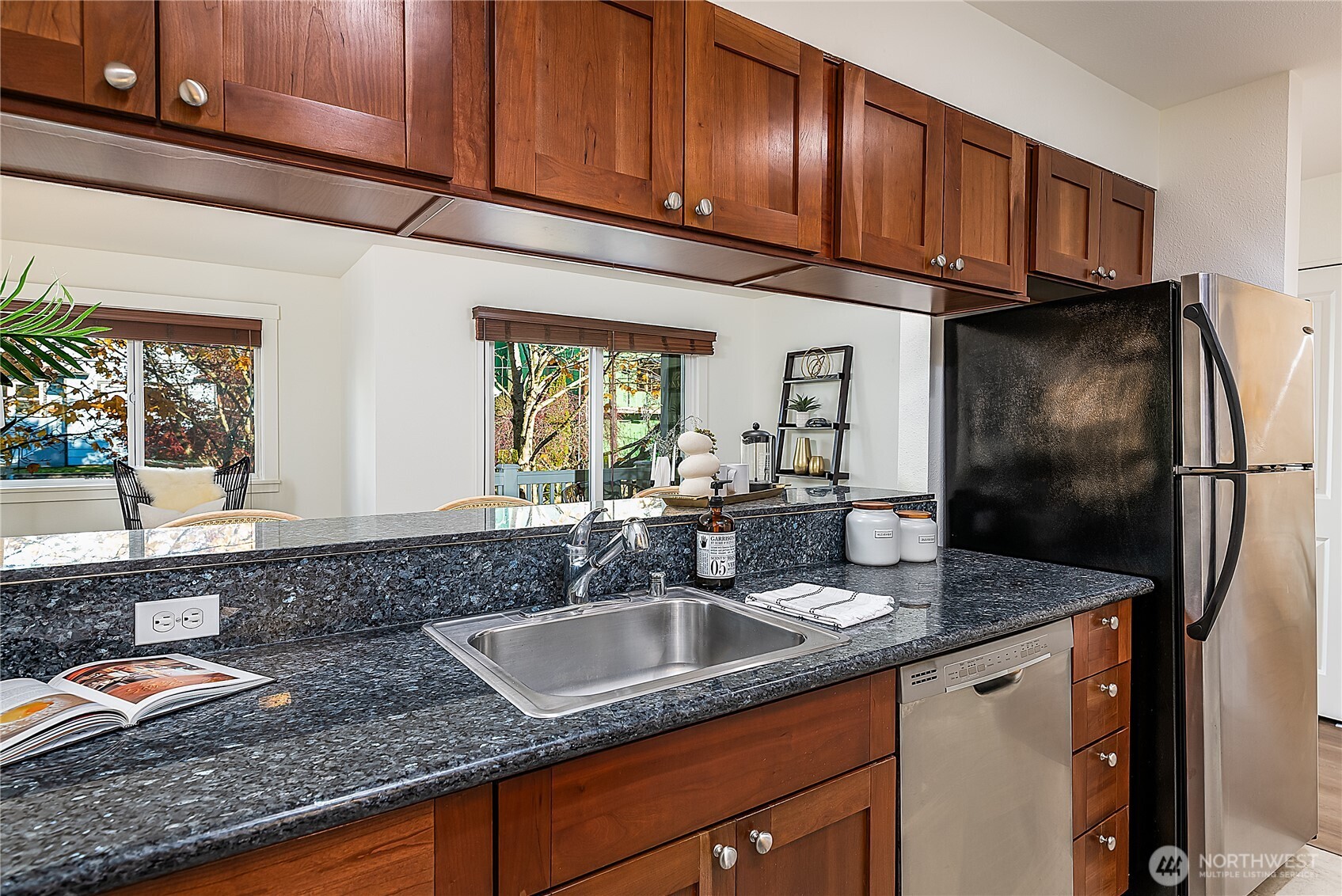 1519 Northwest 59th Street, Unit 101 Seattle, WA 98107 - Photo 11 of 23 a kitchen with stainless steel appliances granite countertop a sink stove and cabinets