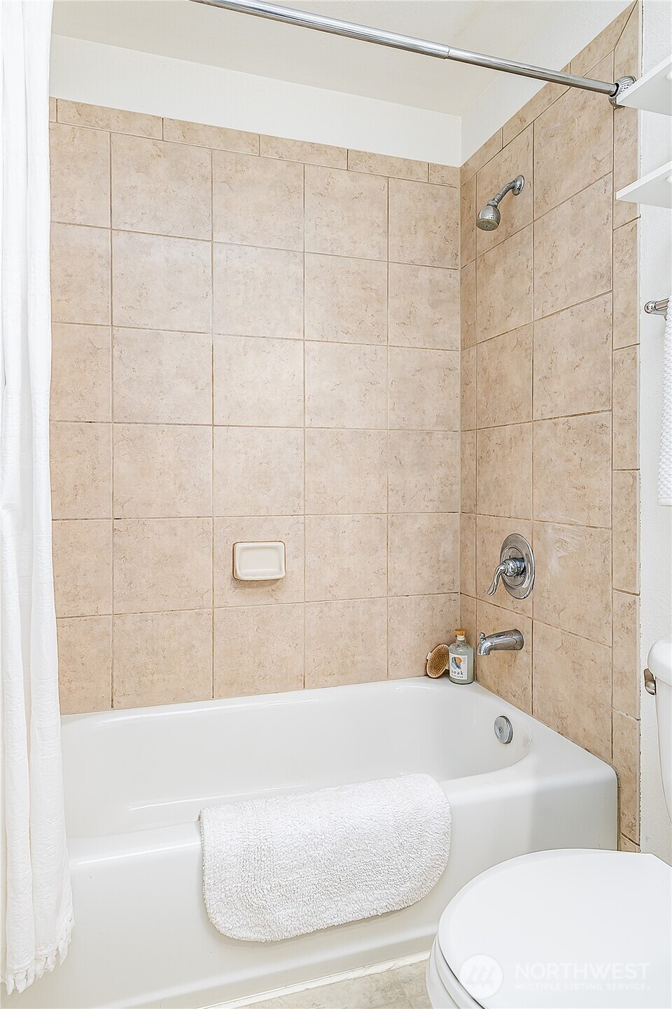 1519 Northwest 59th Street, Unit 101 Seattle, WA 98107 - Photo 18 of 23 a bathroom with a bathtub and a shower