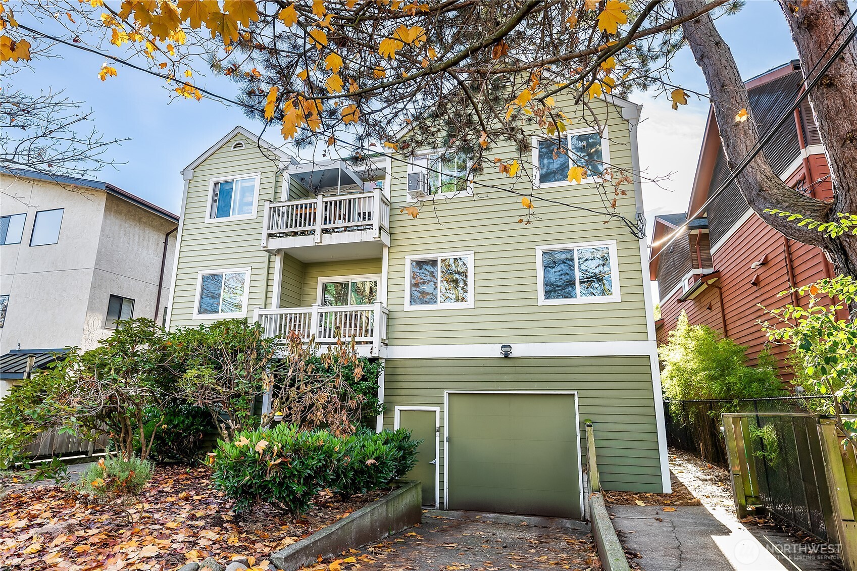 1519 Northwest 59th Street, Unit 101 Seattle, WA 98107 - Photo 22 of 23 a front view of a house with a garden