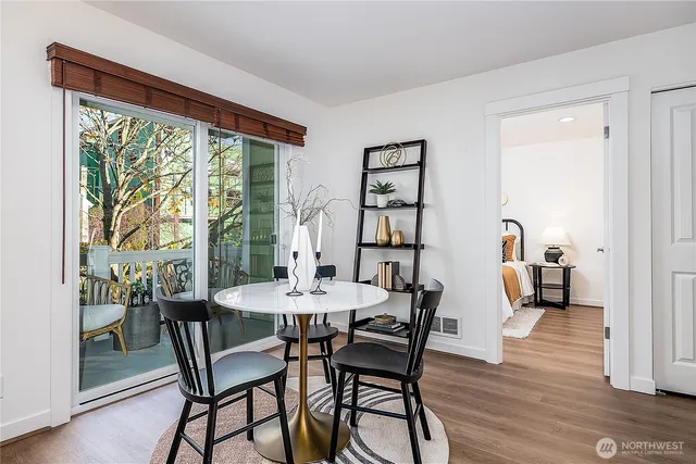 a view of a dining room with furniture and a window
