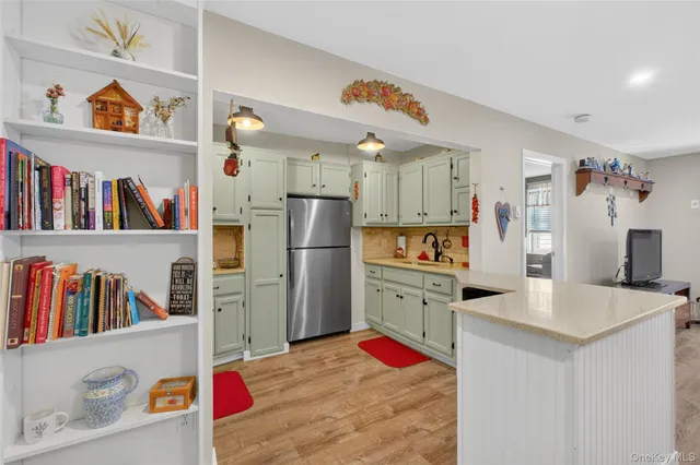 a kitchen with stainless steel appliances a refrigerator and a cabinets