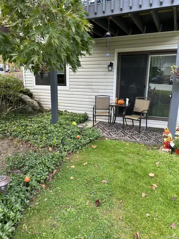 a view of a house with backyard sitting area and garden