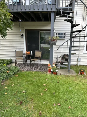 a view of a house with backyard porch and sitting area