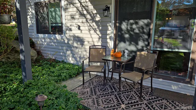 a backyard of a house with table and chairs