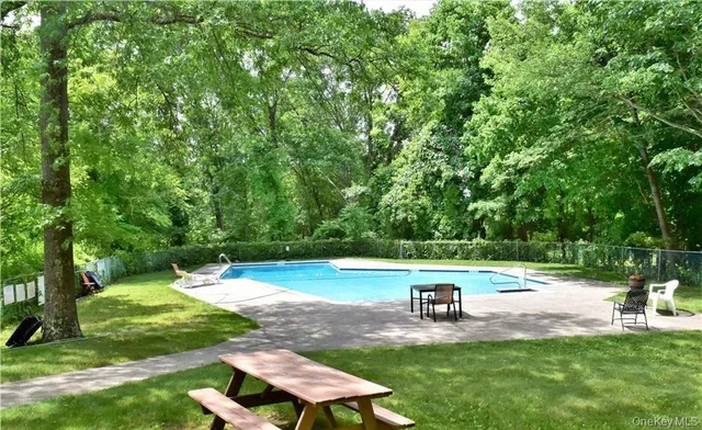 a view of a backyard with swimming pool
