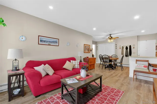 a living room with furniture a rug and a table