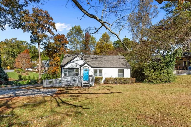 a view of large house with a large tree in front of it