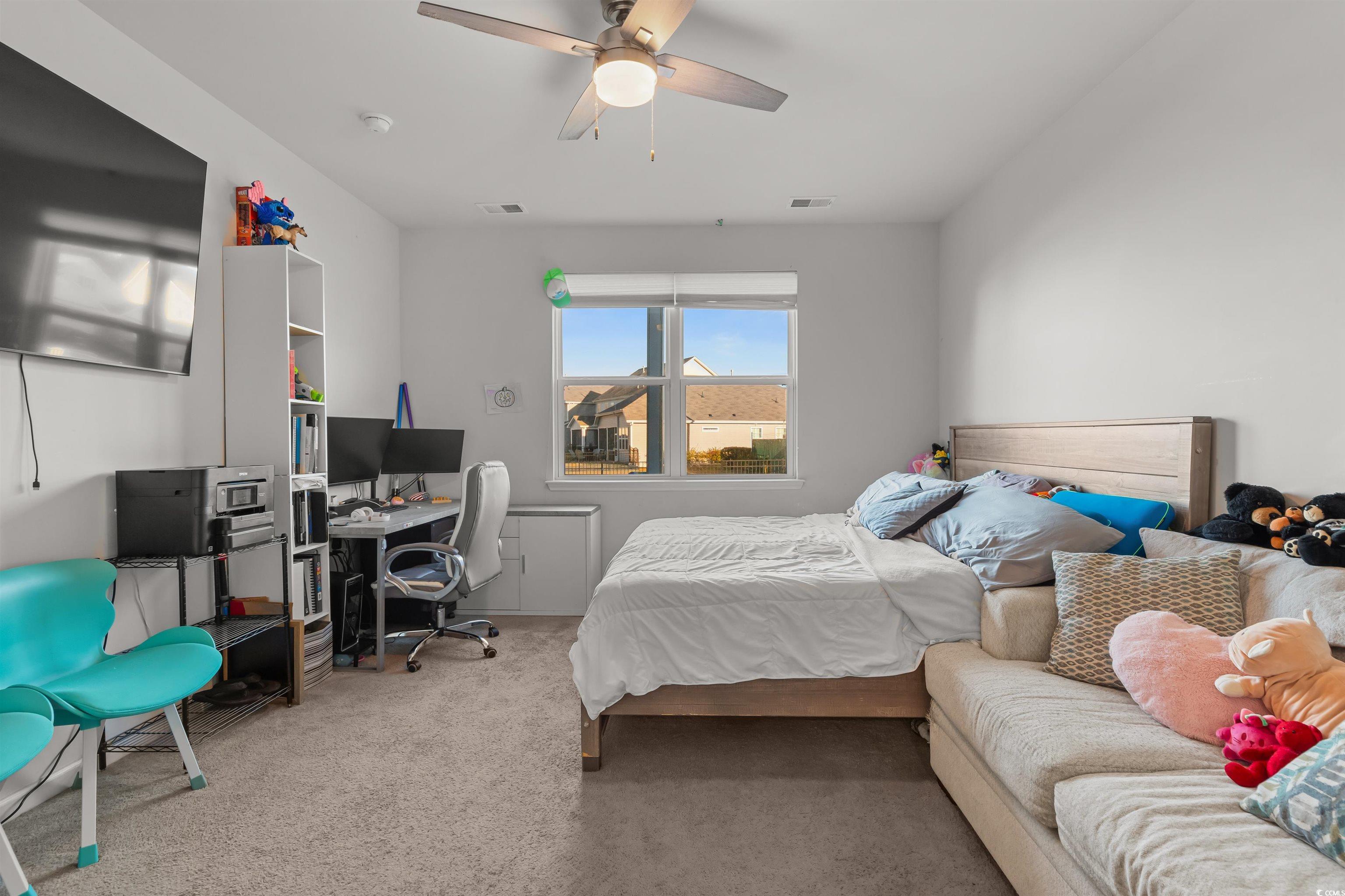 2004 Musgrove Mill Way Myrtle Beach, SC 29579 - Photo 11 of 35 Bedroom featuring carpet flooring, a ceiling fan, and an office area