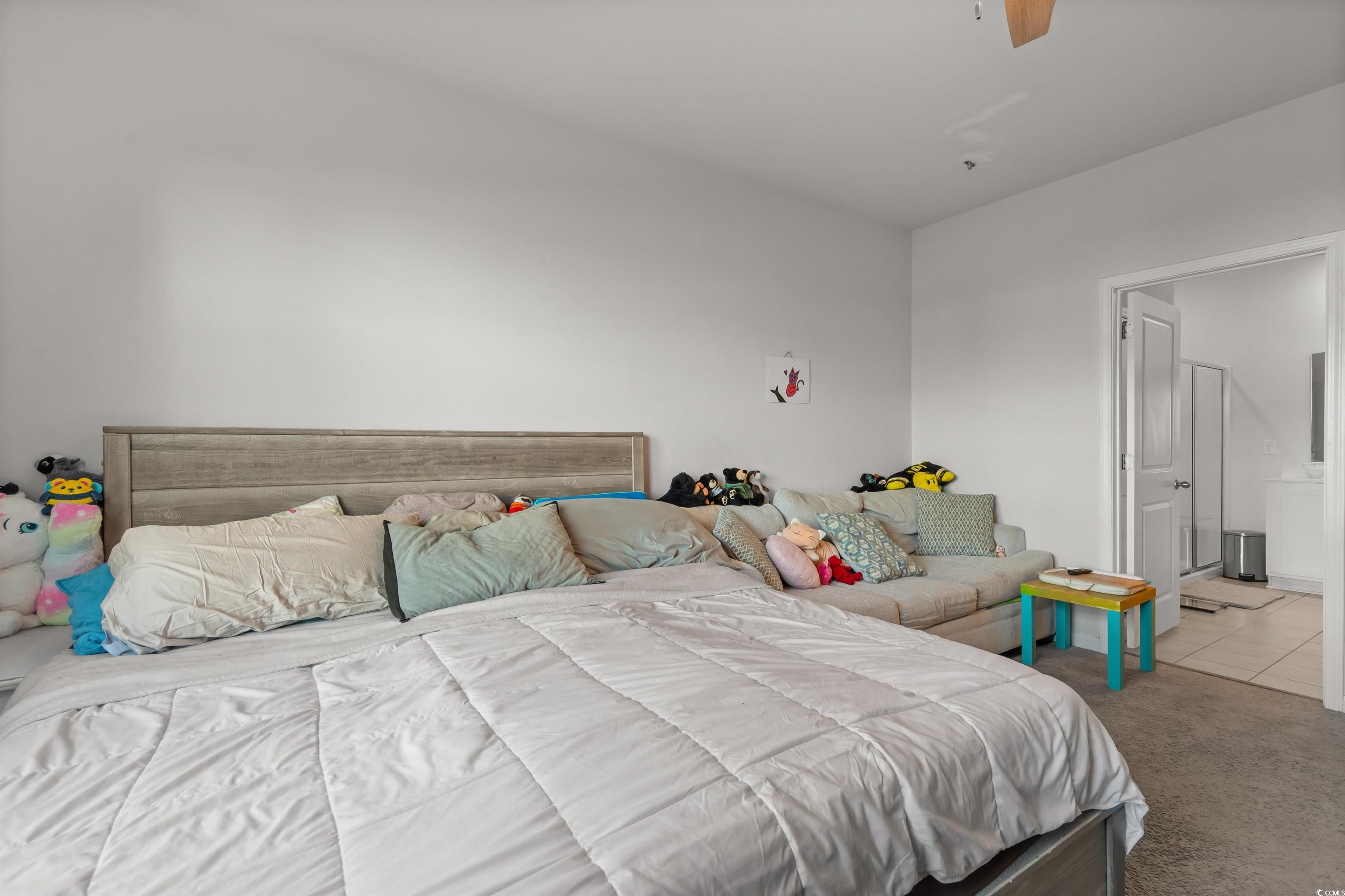 2004 Musgrove Mill Way Myrtle Beach, SC 29579 - Photo 12 of 35 Carpeted bedroom featuring a ceiling fan, ensuite bathroom, and tile patterned floors