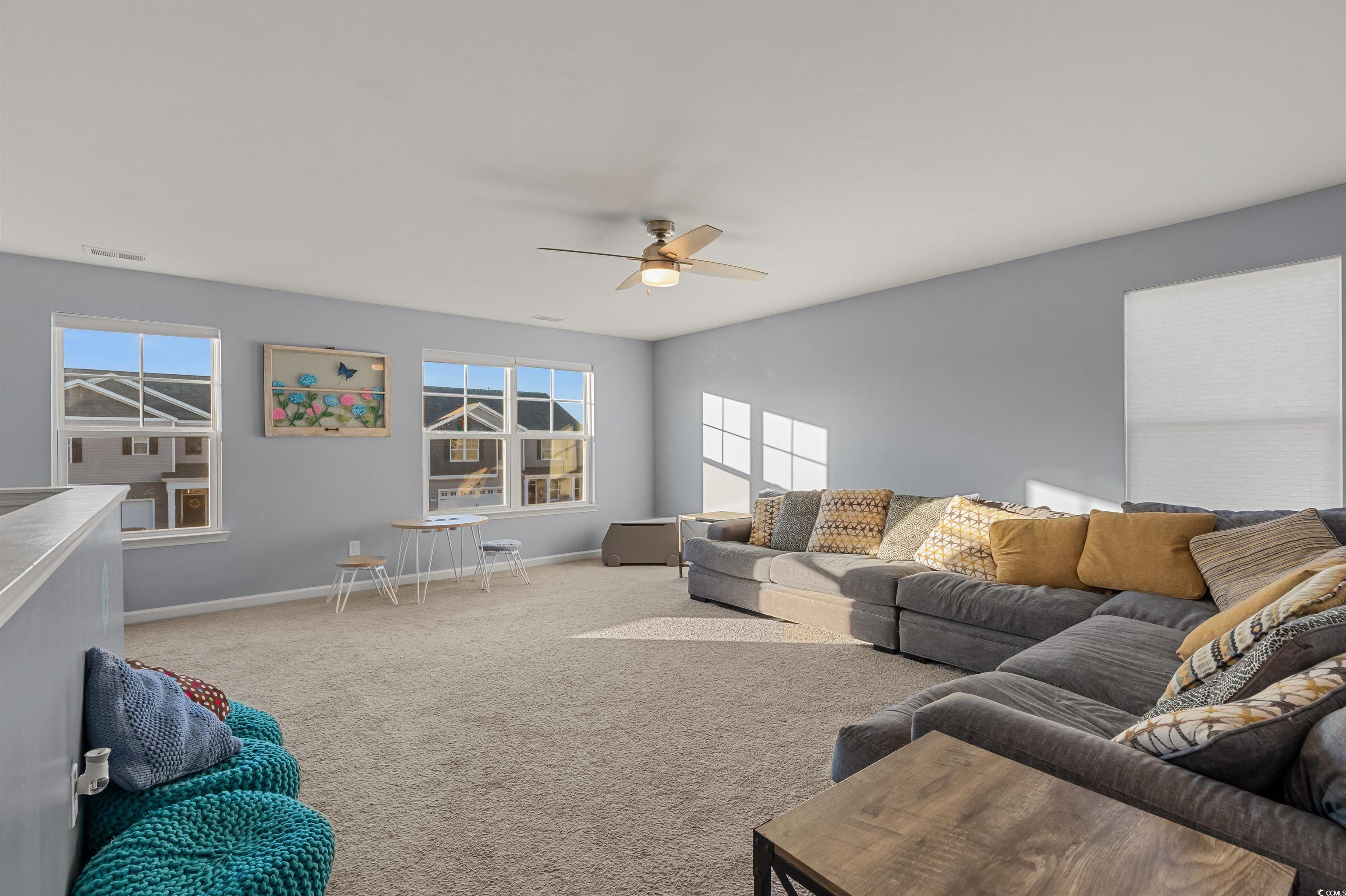 2004 Musgrove Mill Way Myrtle Beach, SC 29579 - Photo 18 of 35 Carpeted living room with baseboards and ceiling fan