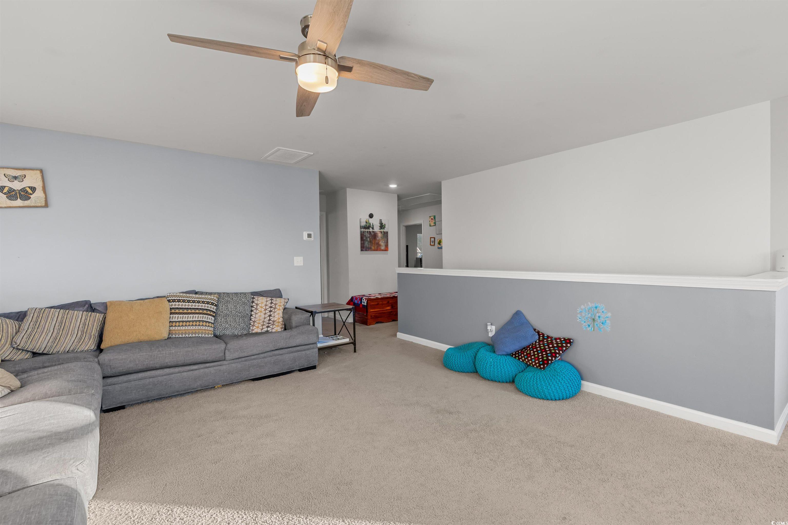 2004 Musgrove Mill Way Myrtle Beach, SC 29579 - Photo 19 of 35 Carpeted living area with baseboards and a ceiling fan