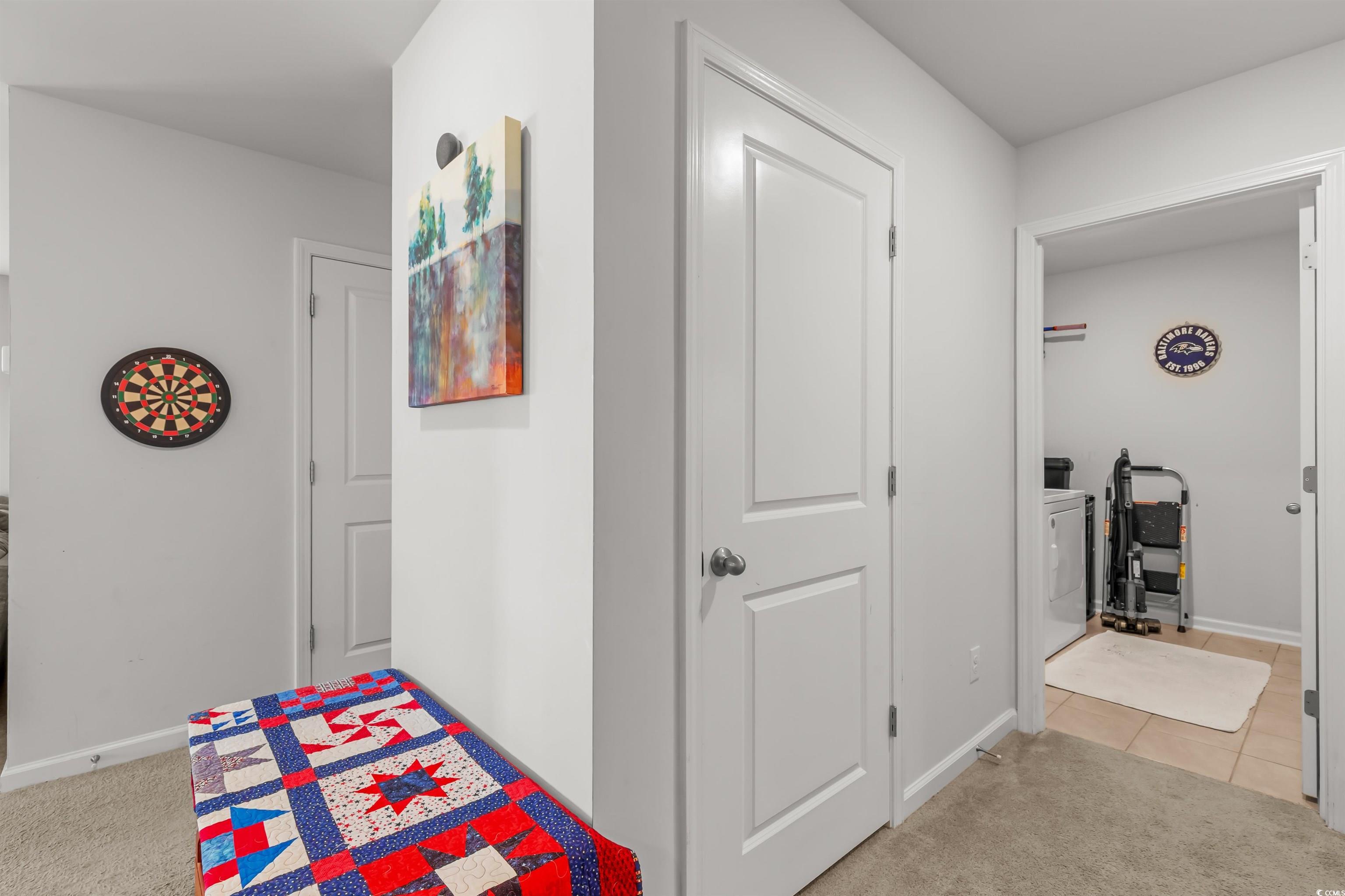 2004 Musgrove Mill Way Myrtle Beach, SC 29579 - Photo 23 of 35 Corridor featuring light colored carpet, light tile patterned floors, and washer / dryer