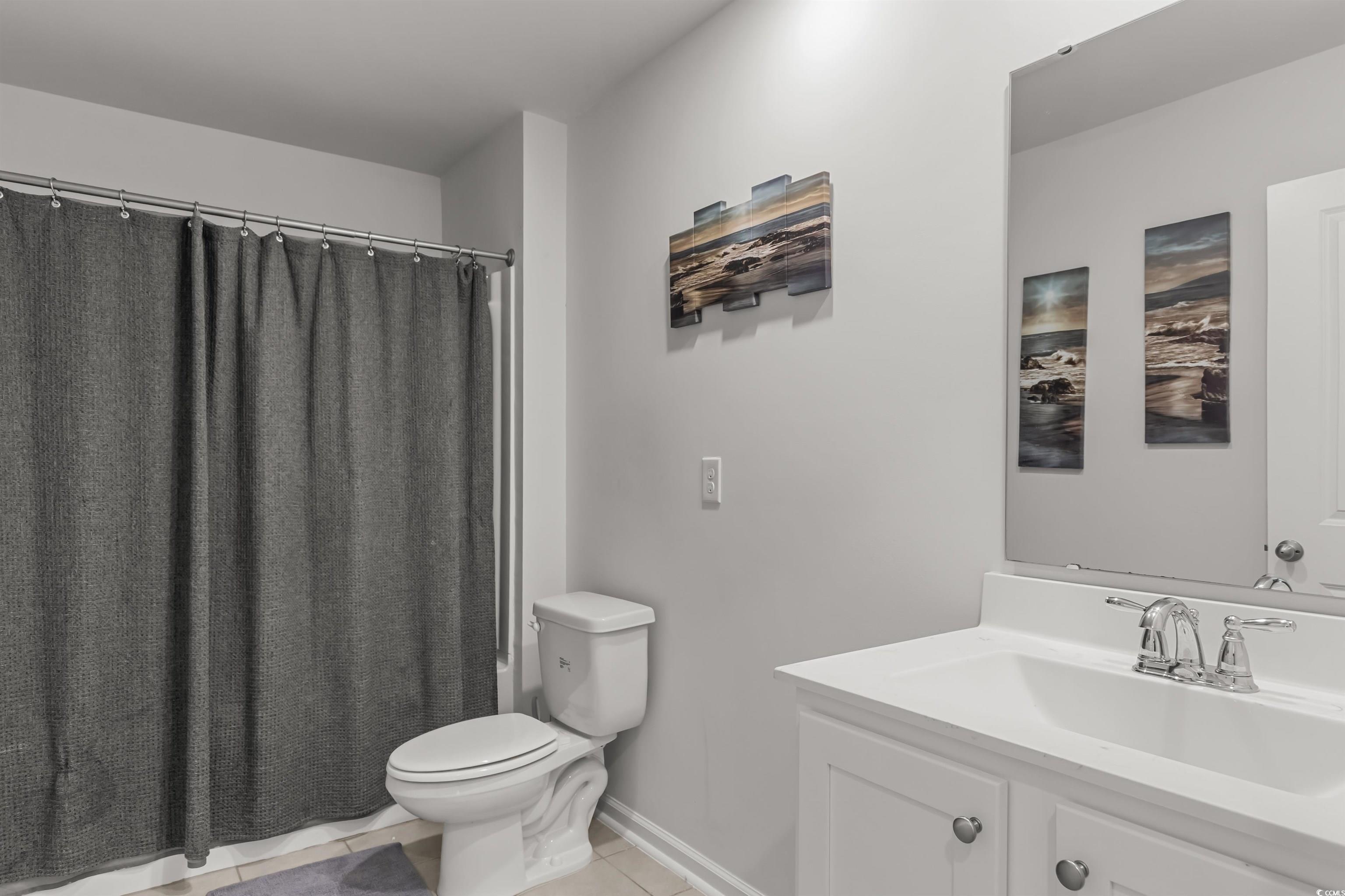 2004 Musgrove Mill Way Myrtle Beach, SC 29579 - Photo 27 of 35 Full bath with vanity, light tile patterned flooring, and shower / bath combination with curtain