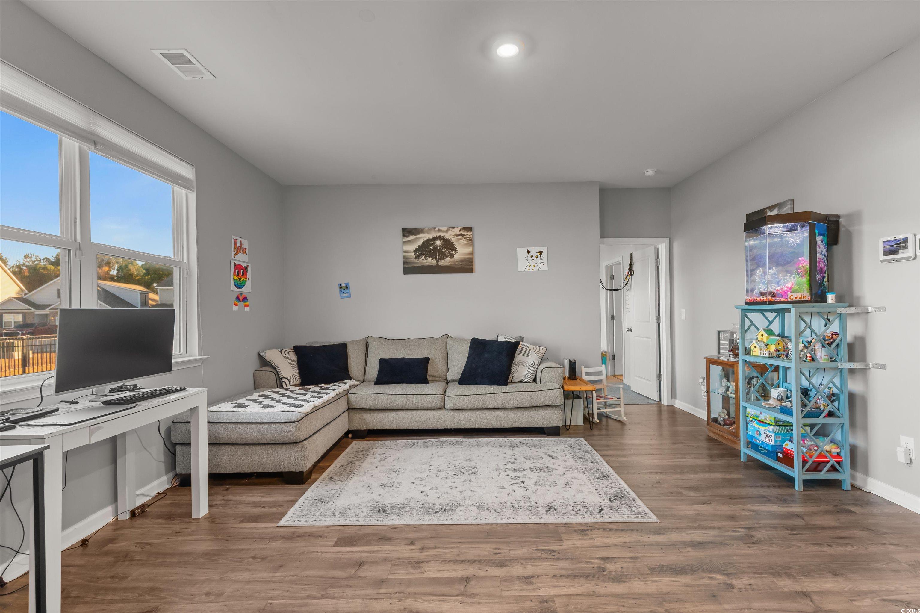 2004 Musgrove Mill Way Myrtle Beach, SC 29579 - Photo 9 of 35 Living area featuring wood finished floors and baseboards