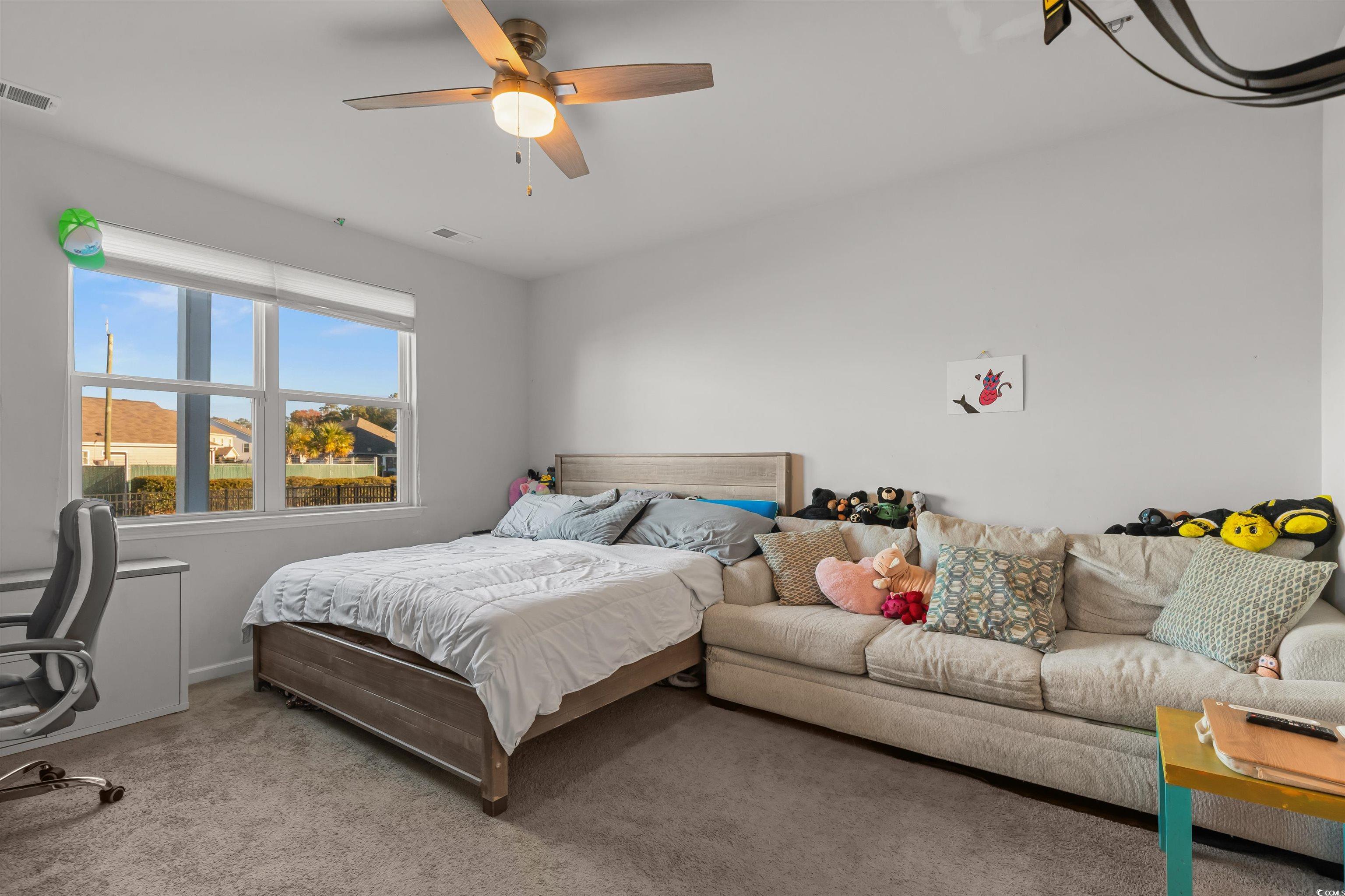2004 Musgrove Mill Way Myrtle Beach, SC 29579 - Photo 10 of 35 Carpeted bedroom featuring a ceiling fan and an office area