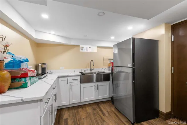 a kitchen with a refrigerator and a stove top oven