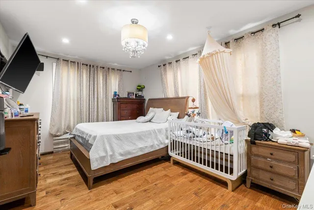 a bedroom with a bed and a tv on the dresser