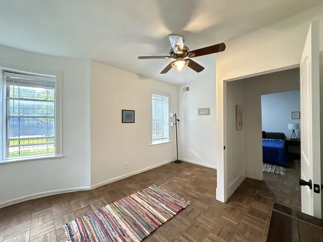 a view of empty room with wooden floor