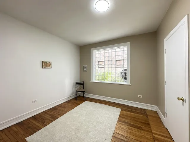 a view of a room with wooden floor and window