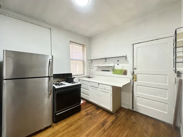 a kitchen with a refrigerator and a stove