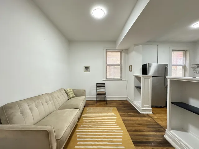 a living room with a couch and a stove top oven