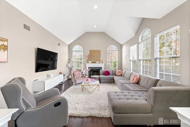 a living room with furniture a large window and a flat screen tv