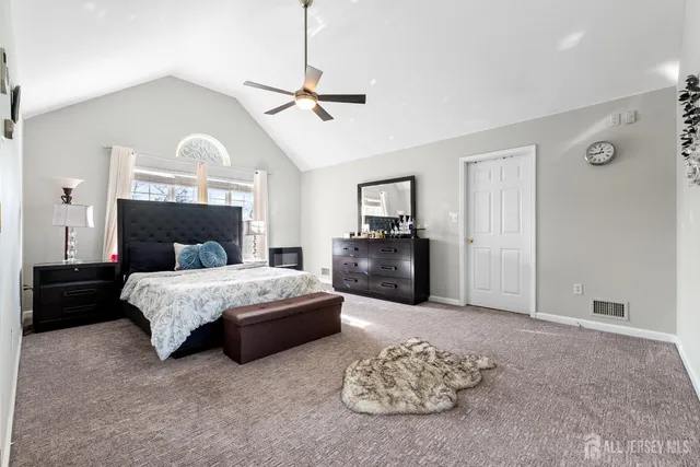 a bedroom with a bed couches and a fireplace