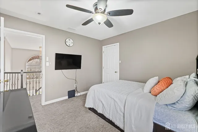 a bedroom with a bed and a tv