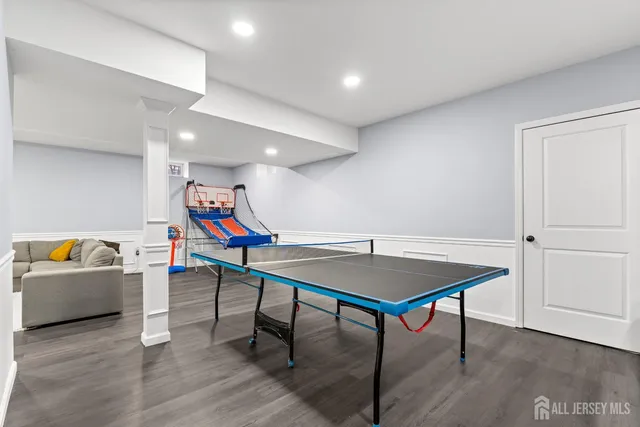 a view of a room with furniture and wooden floor