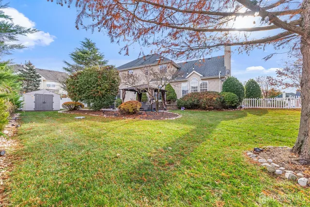 a view of a patio with a table and chairs under an umbrella