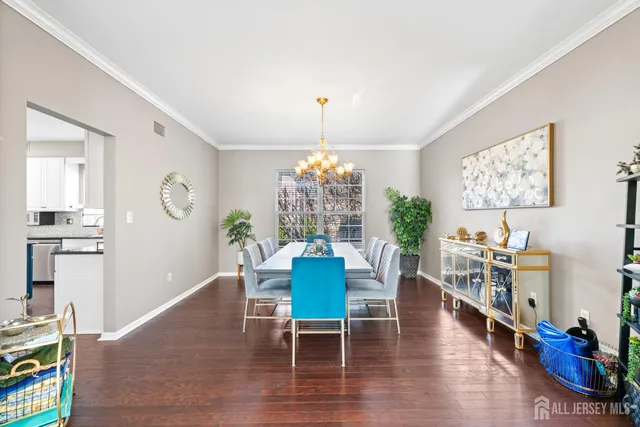 a dining room with furniture a chandelier and wooden floor