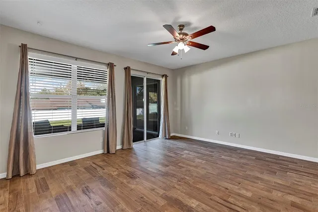 a view of a livingroom with a ceiling fan and window
