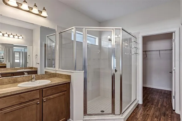 a bathroom with a shower sink and mirror