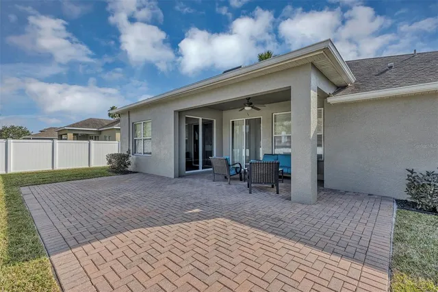 a view of a house with backyard and sitting area