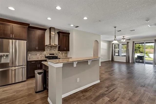 a kitchen with stainless steel appliances a refrigerator sink and stove