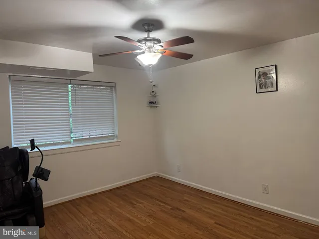 a view of wooden floor and windows in a room