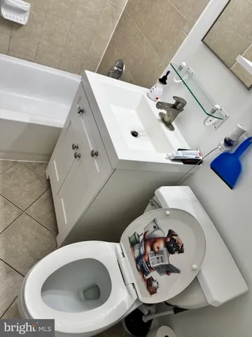 a bathroom with a sink a toilet and a mirror