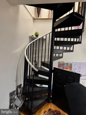 a white toilet sitting next to a bathroom sink and vanity