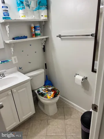 a bathroom with a sink mirror and toilet