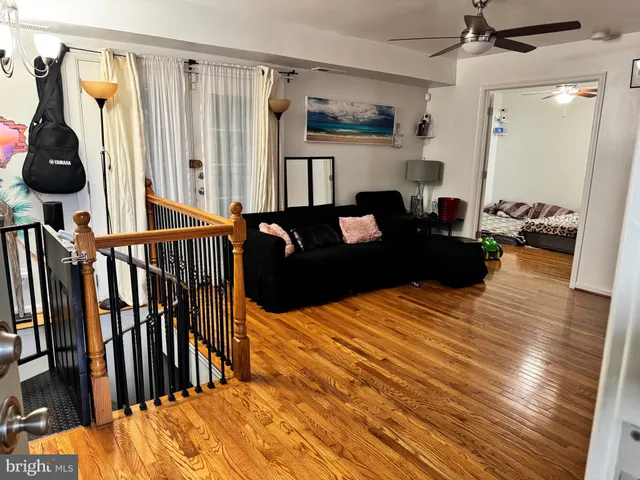 a bedroom with furniture and a wooden floor
