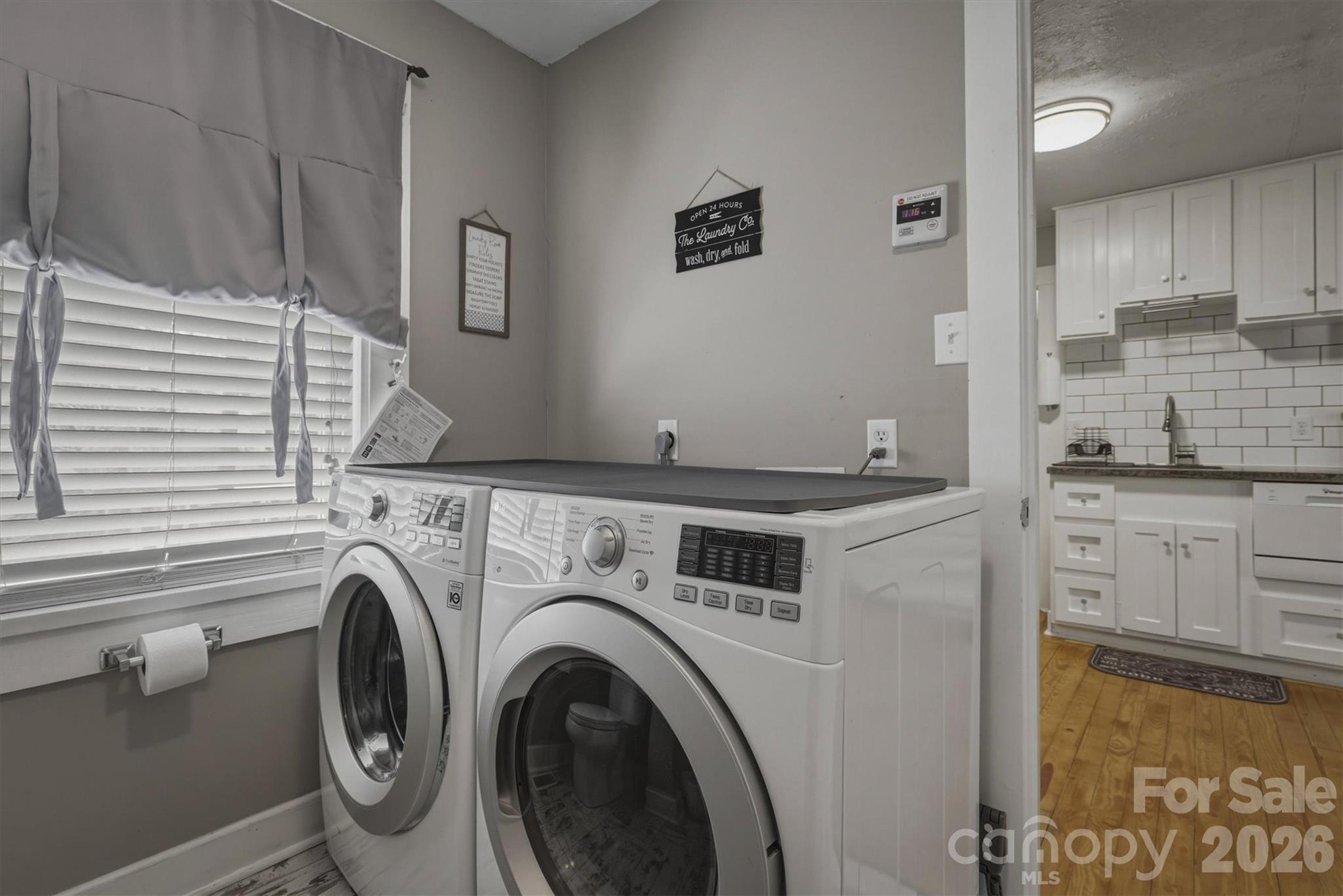 905 Carbon City Road Morganton, NC 28655 - Photo 17 of 29 a kitchen with a sink and a washer dryer